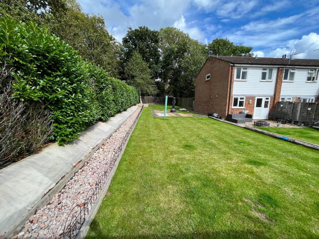 Lot: 127 - LAND WITH PLANNING FOR TWO 2/3 SEMI-DETACHED HOUSES - View of Land from Parking Area - Library Photograph